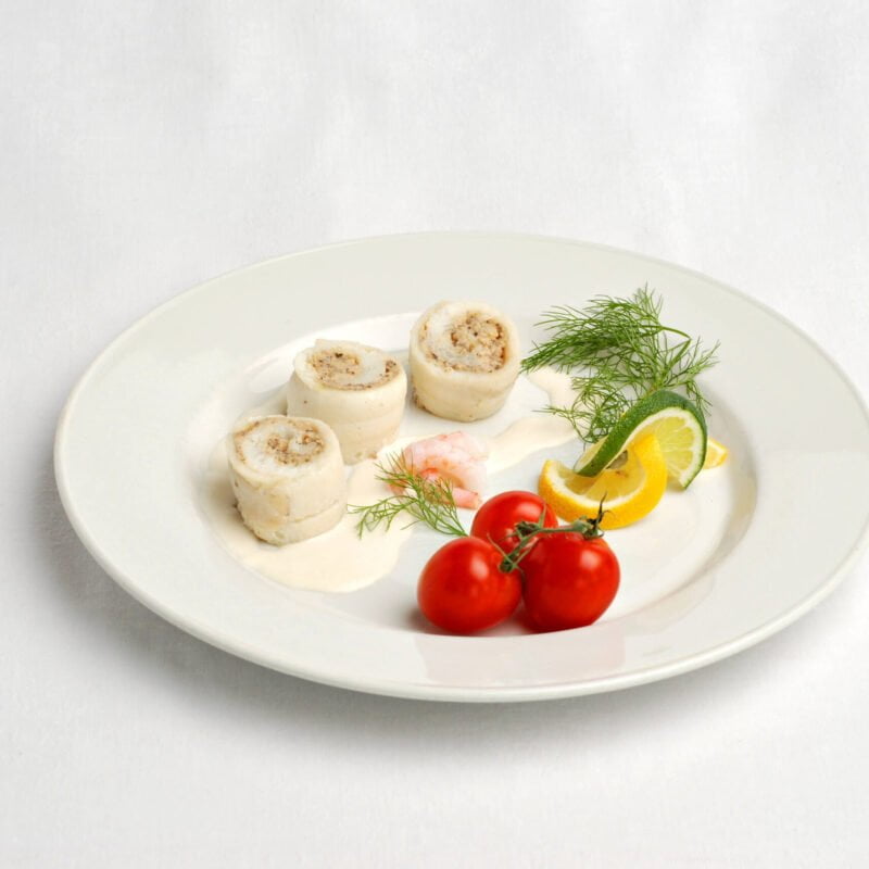 Winter flounder roulades with mushroom mousseline, shrimp, cherry tomatoes and slices of yellow and green lemon together with dill.